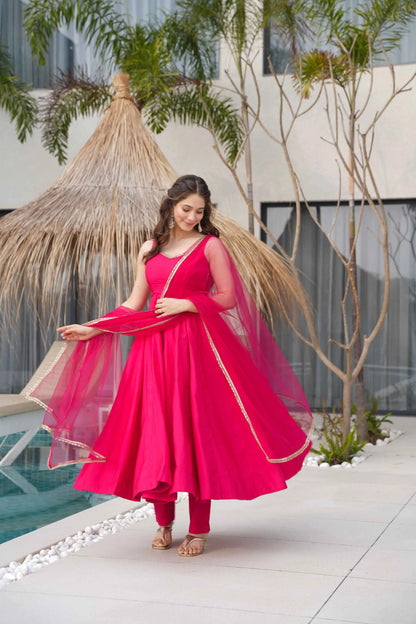 Rani Pink Roman Silk Plain Gown With Mirror Work And Net Dupatta