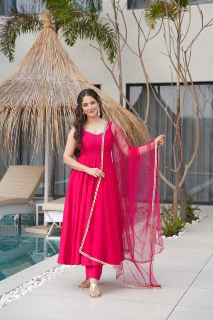 Rani Pink Roman Silk Plain Gown With Mirror Work And Net Dupatta
